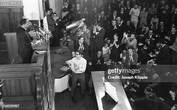 The audience applauds American Civil Rights leader Dr. Martin Luther King Jr speaks from a lecturn at the New York Avenue Presbyterian Church,...