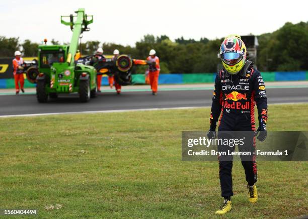 Sergio Perez of Mexico and Oracle Red Bull Racing walks from his car after crashing during practice ahead of the F1 Grand Prix of Hungary at...