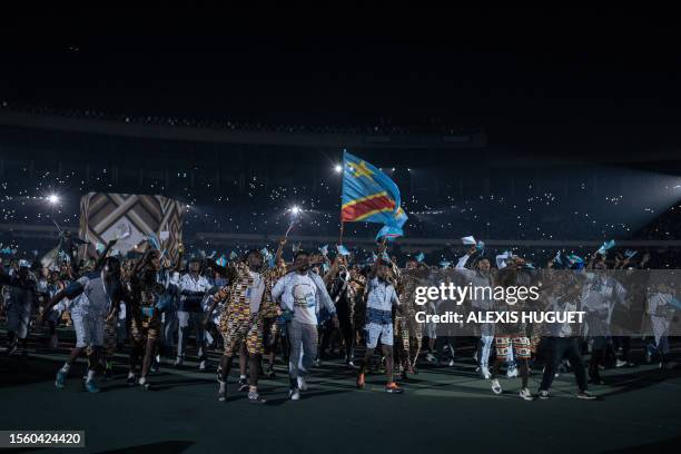 Atheletes from the Democratic Republic of Congo carry their flag as they enter the Stade des Martyrs stadium in Kinshasa on July 28, 2023 during the...