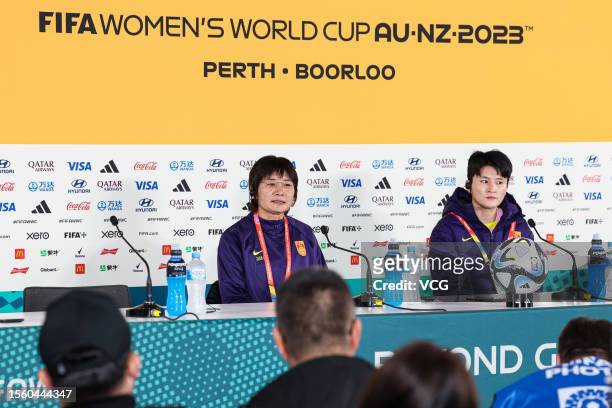 Shui Qingxia, head coach of the Chinese national women's football team, and football player Wang Shanshan attend a press conference ahead of the FIFA...