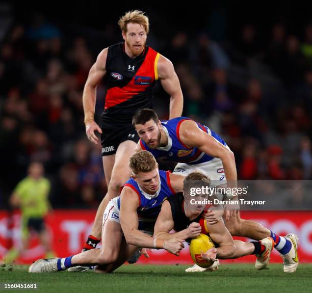 Ben Hobbs of the Bombers handballs during the round 19 AFL match between Essendon Bombers and Western Bulldogs at Marvel Stadium, on July 21 in...