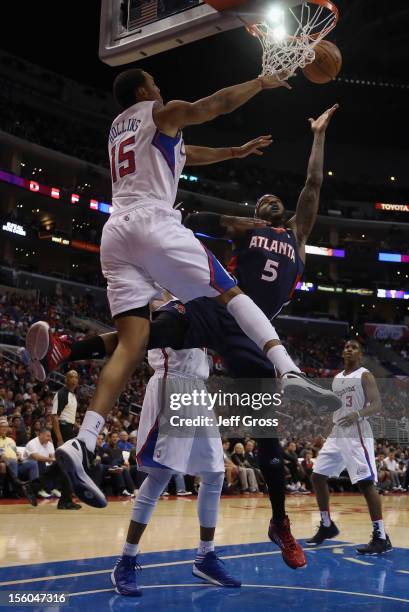 Josh Smith of the Atlanta Hawks drives to the basket while defended by Ryan Hollins of the Los Angeles Clippers in the first half at Staples Center...