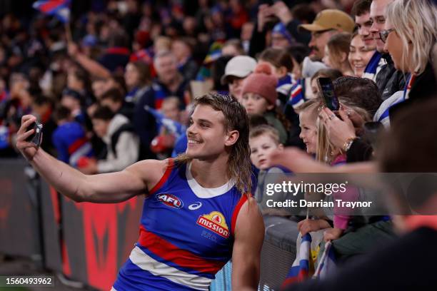 Bailey Smith of the Bulldogs take a selfie with a fan after the round 19 AFL match between Essendon Bombers and Western Bulldogs at Marvel Stadium,...