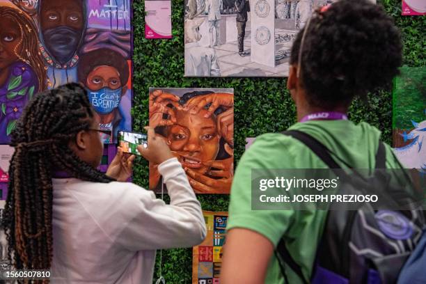 Convention attendees look at art at the Afro-Academic, Cultural, Technological and Scientific Olympics STEM & Visual Arts Gallery during the 114th...