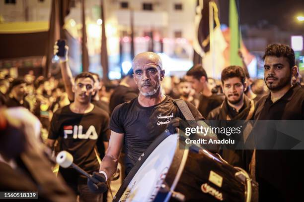 Hundreds of people take part in a mourning ritual, during the month of Muharram on the Islamic calendar, leading up to the day of Ashura, on July 28,...