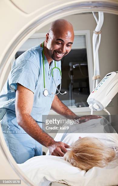 healthcare worker preparing patient for ct scan - cat scan machine stock pictures, royalty-free photos & images
