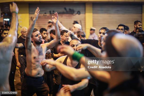 Hundreds of people take part in a mourning ritual, during the month of Muharram on the Islamic calendar, leading up to the day of Ashura, on July 28,...