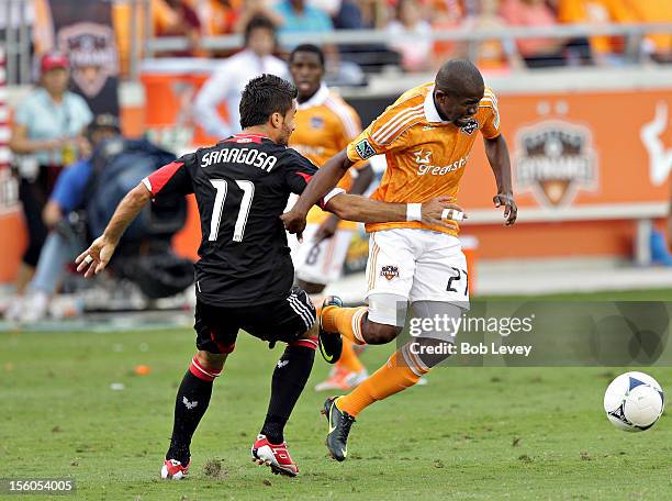 Boniek Garcia of the Houston Dynamo is tripped up by Marcelo Saragosa of the D.C. United in the first half during Leg 1 of the MLS Eastern Conference...