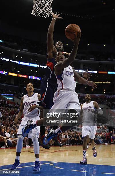 Eric Bledsoe of the Los Angeles Clippers goes up for a layup while being pursued by Ivan Johnson of the Atlanta Hawks in the second half at Staples...