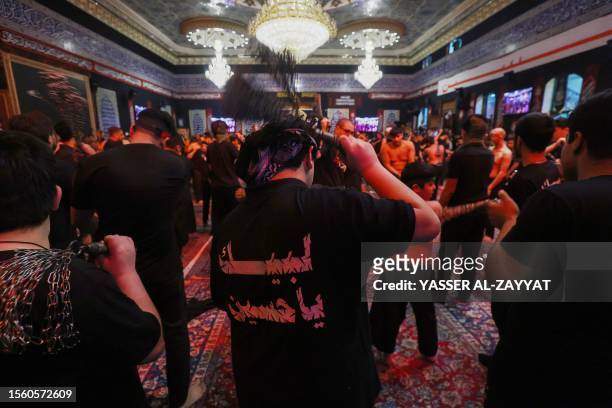 Shiite Muslims take part in a traditional mourning event during Ashura commemorations that mark the killing of Imam Hussein, one of Shiite Islam's...