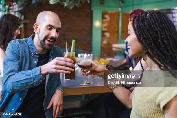 friends drinking cocktails at a bar - bloody mary stock pictures, royalty-free photos & images