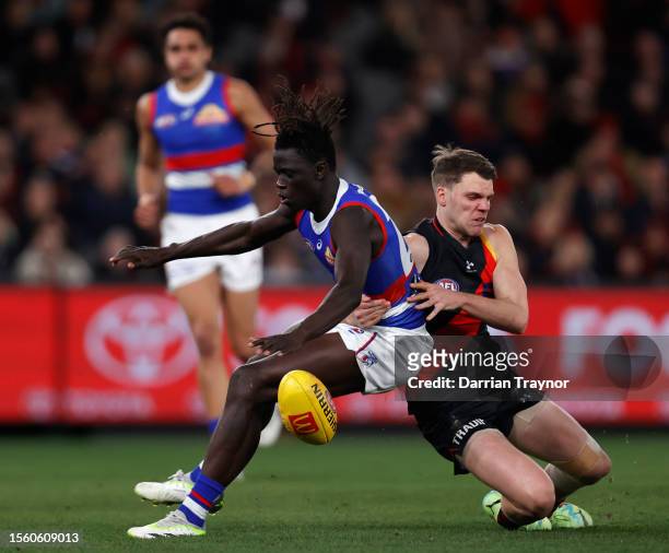 Jordan Ridley of the Bombers tackles Buku Khamis of the Bulldogs during the round 19 AFL match between Essendon Bombers and Western Bulldogs at...