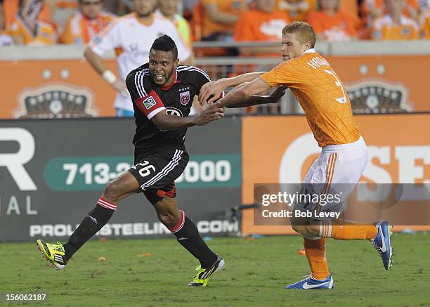 Lionard Pajoy of D.C. United fends off Andre Hainault of the Houston Dynamo in the second half during Leg 1 of the MLS Eastern Conference...