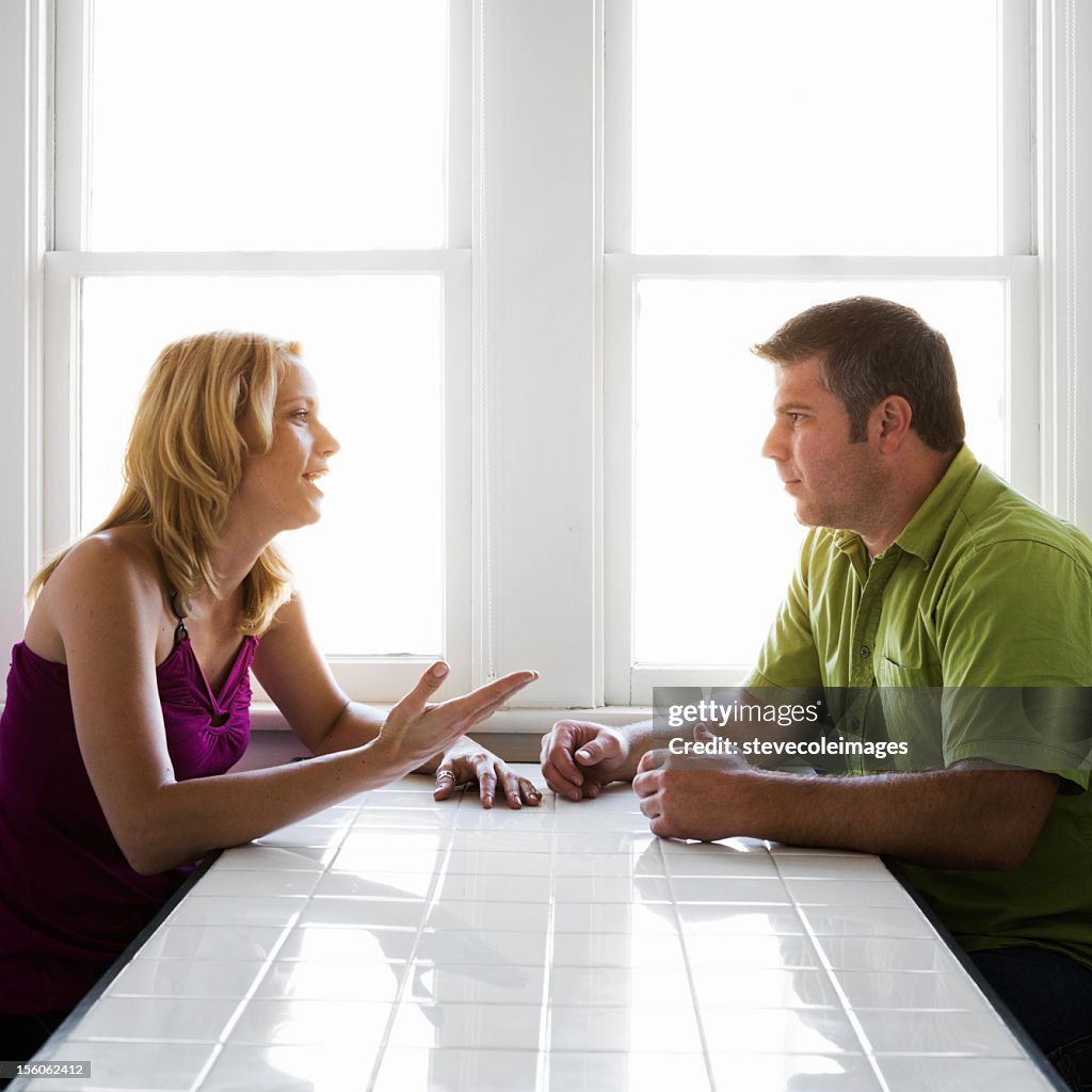 Couple Talking at Kitchen Table
