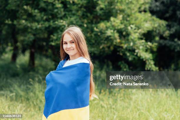 ukrainian child girl  with yellow and blue flag of ukraine in garden - maidan nezalezhnosti stock pictures, royalty-free photos & images
