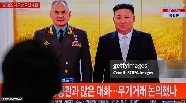 Screen shows an image of North Korean leader Kim Jong Un with Russian Defense Minister Sergei Shoigu at Pyongyang during a news program at the...