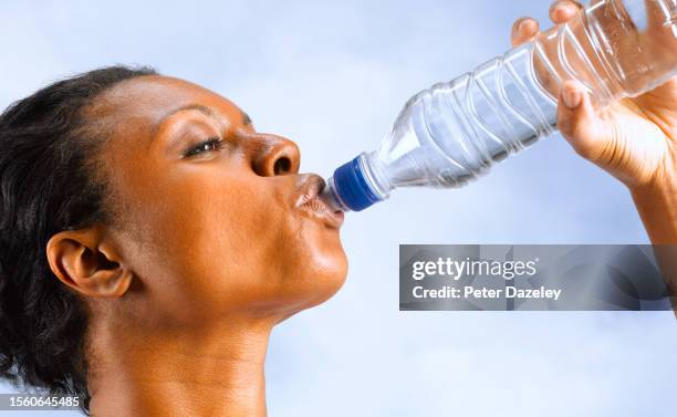 woman with dehydration - one mid adult woman only stock pictures, royalty-free photos & images