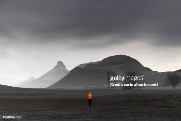 one person enjoy the beautiful landscape in highlands during a summer cloudy day, iceland, europe - black sand iceland stock pictures, royalty-free photos & images