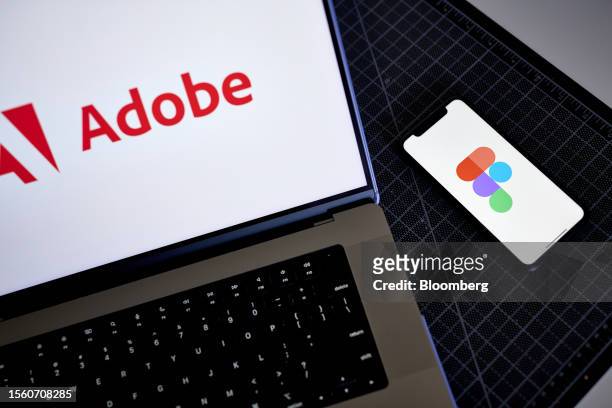The Figma logo on a smartphone and Adobe logo on a laptop arranged in the Brooklyn borough of New York, US, on Friday, July 28, 2023. Adobe Inc.s $20...