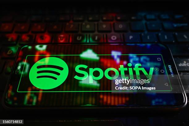 In this photo illustration a Spotify logo is displayed on a smartphone.