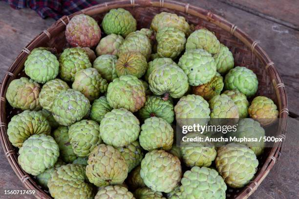 group of custard apple fruit in bamboo tray,sa kaeo,thailand - sugar apple stock pictures, royalty-free photos & images