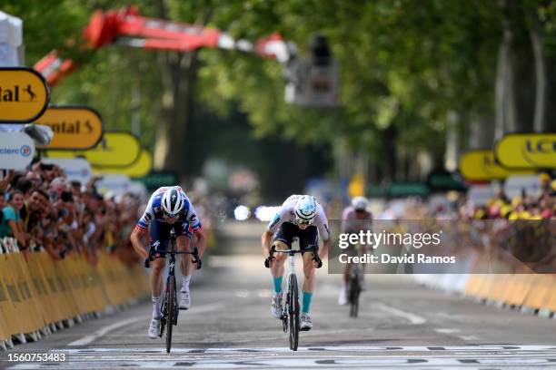 Kasper Asgreen of Denmark and Team Soudal - Quick Step and stage winner Matej Mohoric of Slovenia and Team Bahrain Victorious sprint at finish line...