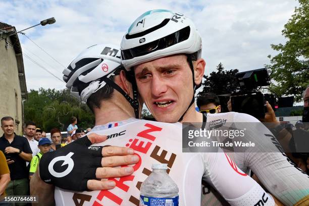 Ben O'connor of Australia and Ag2R Citroën Team and stage winner Matej Mohoric of Slovenia and Team Bahrain Victorious react after the stage nineteen...