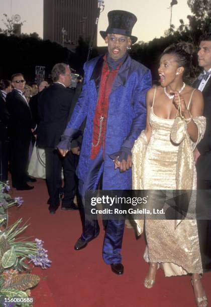 Athlete Dennis Rodman and Actress Vivica A. Fox attend the 69th Annual Academy Awards on March 24, 1997 at Shrine Auditorium in Los Angeles,...