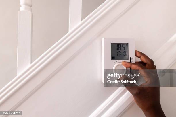 turning thermostat down at home - turn stock pictures, royalty-free photos & images