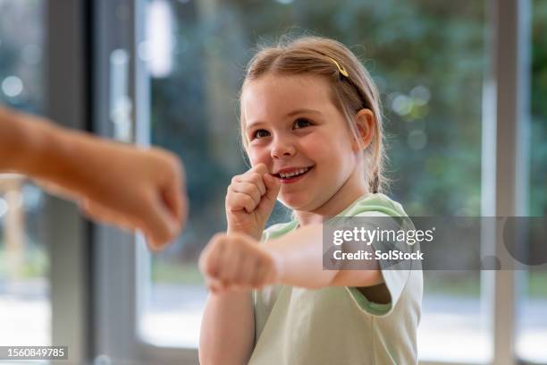 student becomes the master - martial arts kid stock pictures, royalty-free photos & images