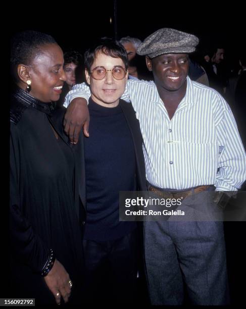Singer Miriam Makeba, musician Paul Simon and Bonagni Holphe attend the party for 'Asinamali' on April 23, 1987 at Stringfellow's in New York City.