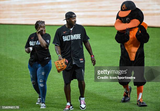 July 28: Sonsy Gaba , former Baltimore Orioles outfielder Adam Jones and the Orioles Bird walk off the field after the ceremonial first pitch...