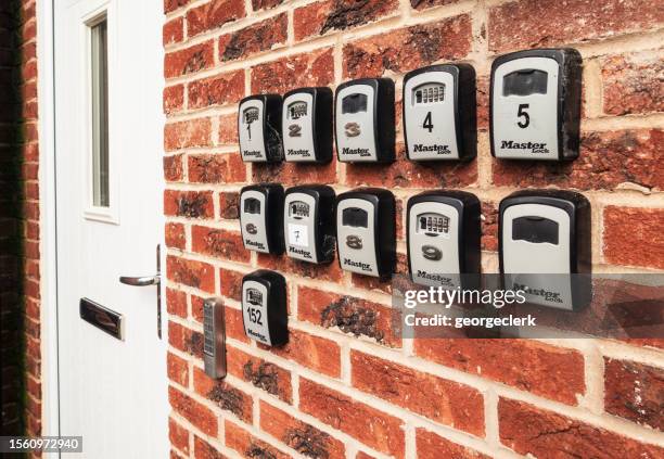 multiple lock-boxes outside apartment block - lock box stock pictures, royalty-free photos & images