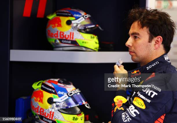 Sergio Perez of Mexico and Oracle Red Bull Racing prepares to drive in the garage during practice ahead of the F1 Grand Prix of Hungary at...