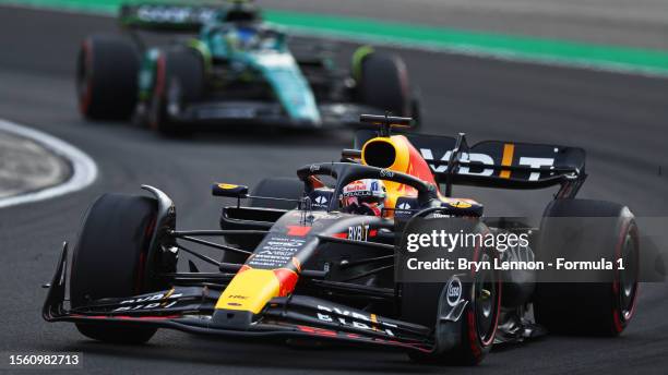 Max Verstappen of the Netherlands driving the Oracle Red Bull Racing RB19 leads Fernando Alonso of Spain driving the Aston Martin AMR23 Mercedes on...