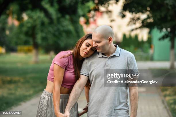 couple enjoying park tranquility after husband's tough battle with cancer - cellphone cancer illness stock pictures, royalty-free photos & images