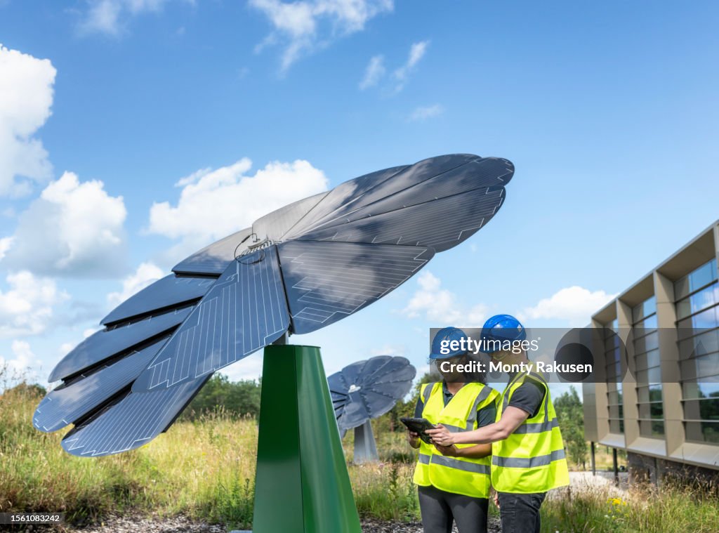 Solar Sunflowe Engineers Inspecting Solar Sunflower Shaped Panels That Fold And Track ...