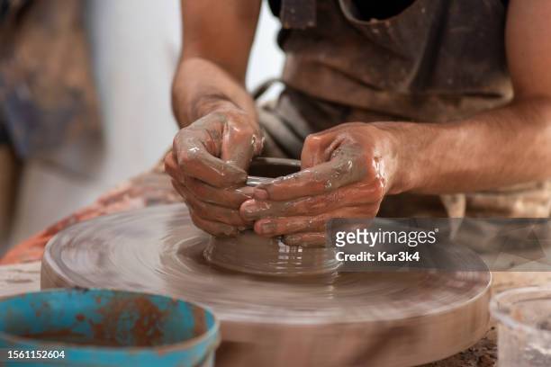 male ceramists working with clay on a rustic lathe, artisanal work with clay, handcrafted ceramics from brazil - vaso de barro stock pictures, royalty-free photos & images