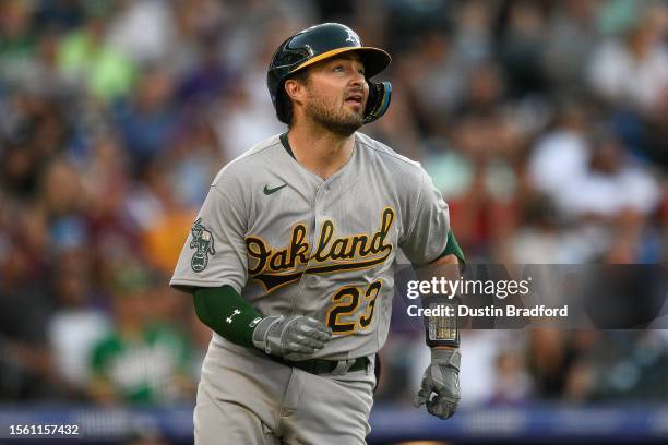 Shea Langeliers of the Oakland Athletics watches the flight of a ball that ended up an RBI triple in the second inning against the Colorado Rockies...