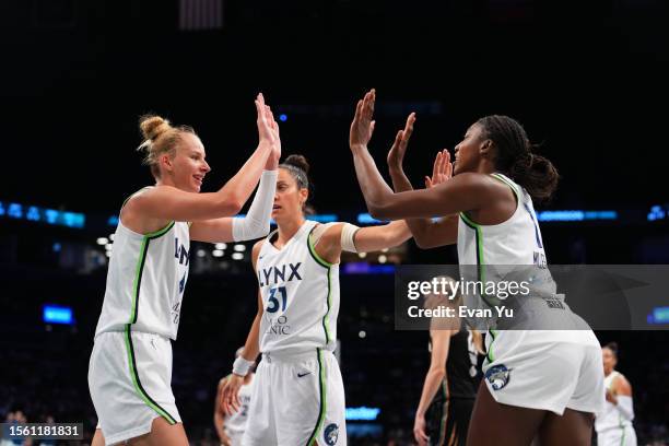 Dorka Juhász high fives teammate Diamond Miller of the Minnesota Lynx during the game against the New York Liberty on July 28, 2023 at Barclays...