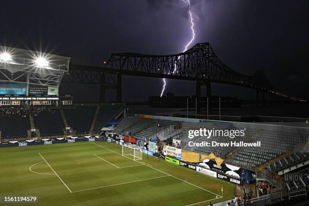 Lighting strikes near a ship passing under the Commodore Barry Bridge along the Delaware River as seen from at Subaru Park on July 28, 2023 in...