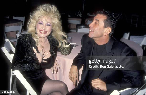 Musician Dolly Parton and Hollywood Manager/Producer Sandy Gallin attend the Party to Celebrate Kelly Klein's New Book 'Pools' on November 19, 1992...