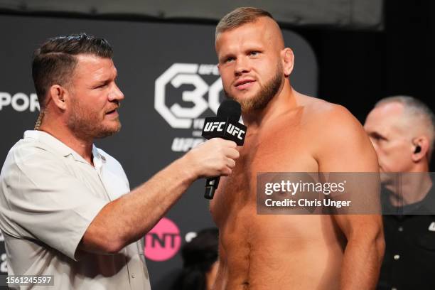 Marcin Tybura of Poland is interviewed by Michael Bisping during the UFC Fight Night ceremonial weigh-in at The O2 Arena on July 21, 2023 in London,...