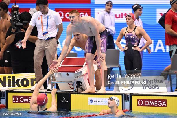 Britain's Tom Dean celebrates with Freya Anderson , Jacob Whittle and Lucy Hope after competing a heat of the mixed 4x100m freestyle relay swimming...