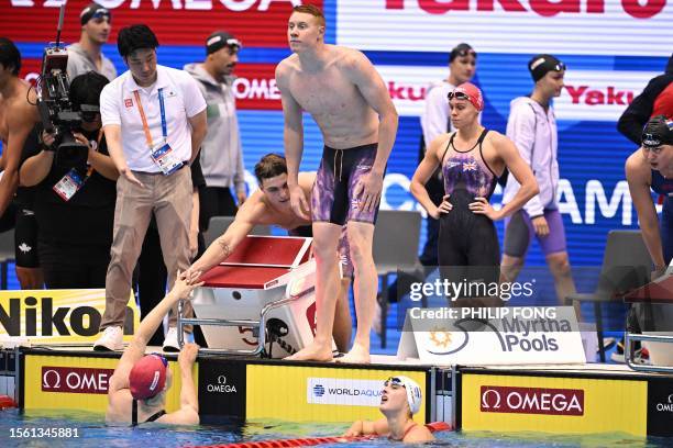 Britain's Freya Anderson, Jacob Whittle, Tom Dean and Lucy Hope react after competing in a heat of the mixed 4x100m freestyle relay swimming event...