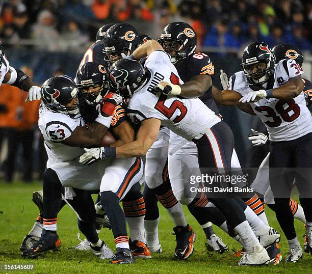 Matt Forte of the Chicago Bears is tackled by Bradie James of the Houston Texans and Barrett Ruud on November 11, 2012 at Soldier Field in Chicago,...