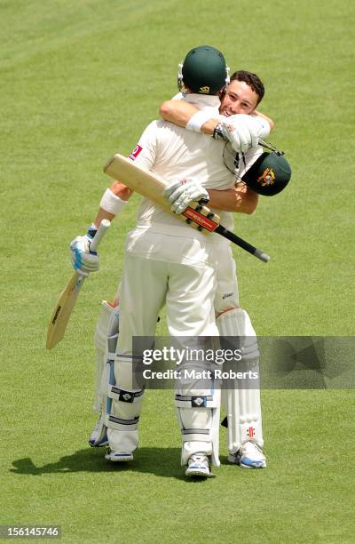 Ed Cowan of Australia celebrates his century with Michael Clarke during day four of the First Test match between Australia and South Africa at The...