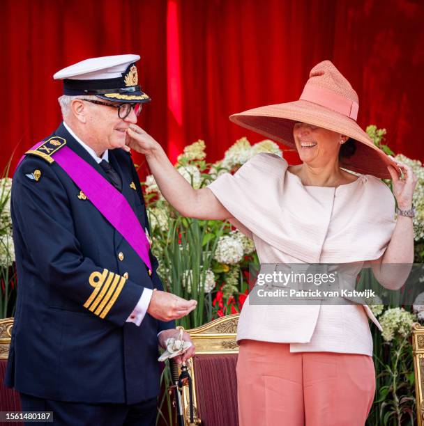 Belgian Prince Laurent (L) is pictured with Princess Claire (R) and her  daughter Princess Louise on the podium during the military parade on the  occasion of Belgium?s National Day in Brussels, Belgium