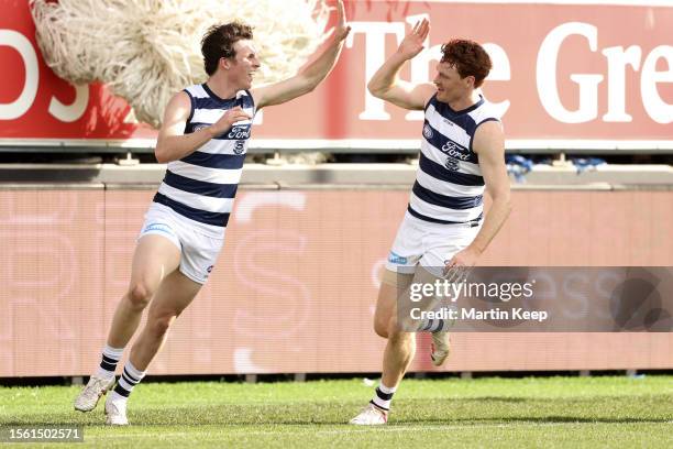 Max Holmes of the Cats celebrates a goal with Gary Rohan during the round 20 AFL match between Geelong Cats and Fremantle Dockers at GMHBA Stadium,...