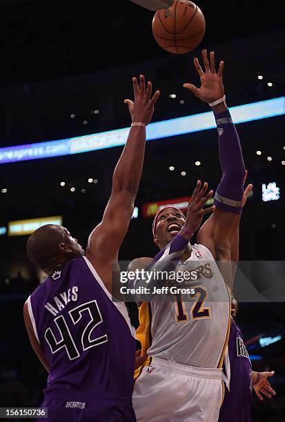 Dwight Howard of the Los Angeles Lakers shoots over Chuck Hayes of the Sacramento Kings in the first half at Staples Center on November 11, 2012 in...